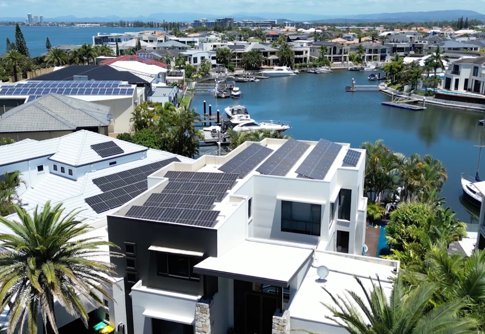 Aerial view of a waterfront home with rooftop solar at Paradise Point, Gold Coast